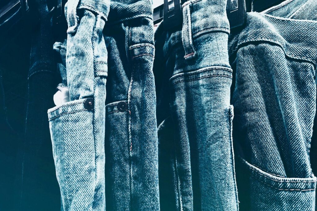 pexels-photo-603022-603022 A collection of blue denim jeans hanging closely on a rack in a retail store.